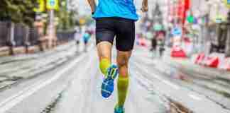Man running on city street using Strava
