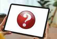 Can iPads get malware? Here’s what you need to know (2025) Person holding iPad with question mark