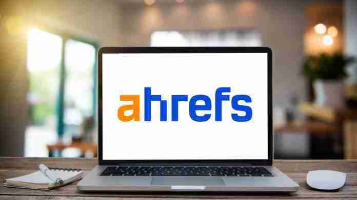 Desk Laptop with blank screen on table Ahrefs logo on laptop