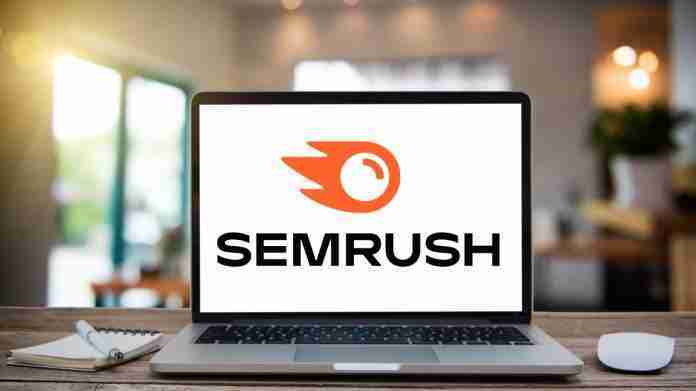 Desk Laptop with blank screen on table Semrush logo on laptop